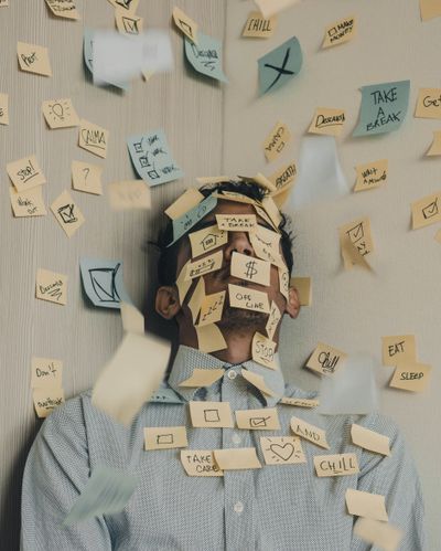 Man overloaded with post-it notes